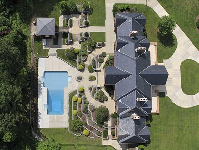 Land. The home is located on seven acres and inclu