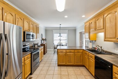 The Kitchen has tile flooring, an eat-in area, beautiful maple cabinets and a counter bar. ALL appliances remain (Refrigerator, Microwave, Electric Stove, and Dishwasher)!