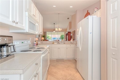 Kitchen featuring kitchen peninsula, white applian