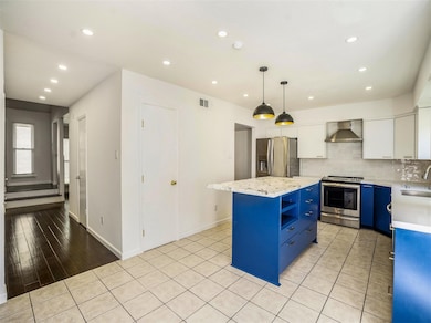 Huge island kitchen is a chef's dream with  pantry, new cabinets, appliances plus high ceiling and recessed lighting.