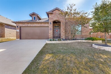 View of front of house with a front lawn and brick siding