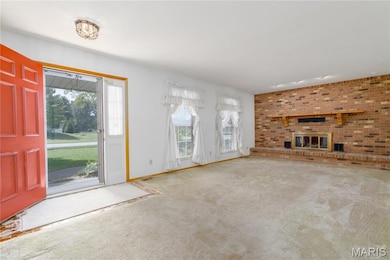 Living room with carpet and a brick fireplace
