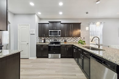 Kitchen is open to living but still private.