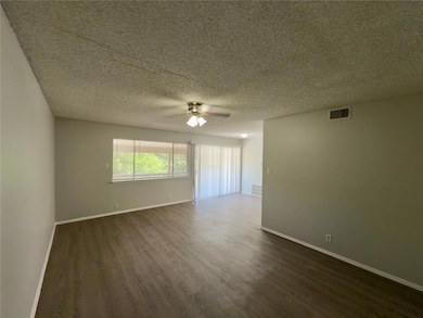 Unfurnished room with dark wood finished floors, 