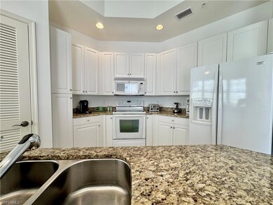 Kitchen with white cabinets, granite countertops, 