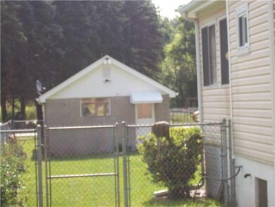 Exterior Back. Detached one car garage with access