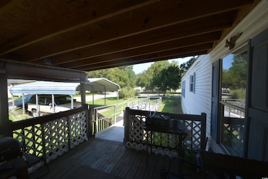 Deck with a lawn and a carport