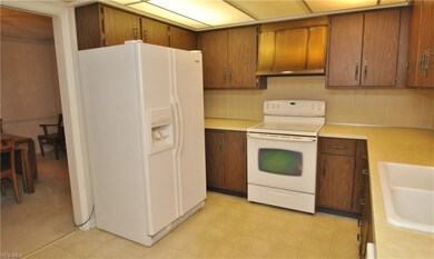 The kitchen includes: side-by-side refrigerator, e