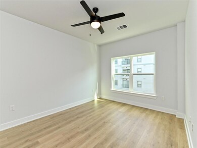 Empty room with light wood-style floors, ceiling 