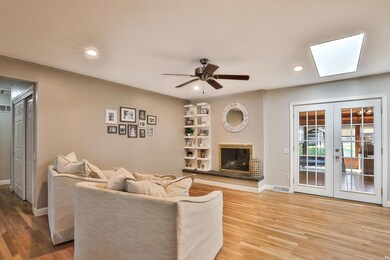 Remarkable Family Room claims recessed lights with dimmer switch, ceiling fan, raised hearth gas fireplace, skylight and French Door that exits to the Sun Room.