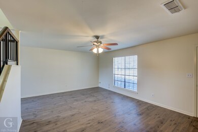 Living room with windows looking out to front walk