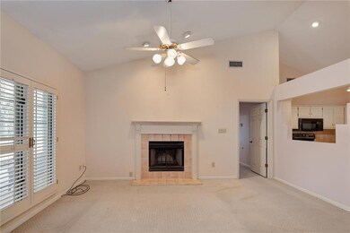 Unfurnished living room featuring light carpet, a 