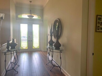 GRAND ENTRY DOUBLE FRONT DOOR INTO THE FOYER