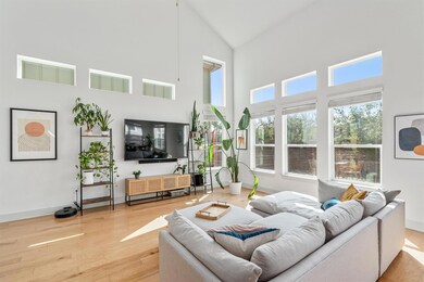 Living area with high vaulted ceiling and wood fi