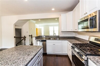 Granite countertops, an oversized island, and cust