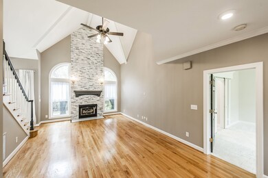 Living Room 23x13 - Features a fabulous 18' vaulted ceiling, quarter moon arched clerestory windows, Hardwood floors, Crown molding and ceiling beams.