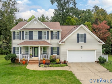 Colonial home with covered porch, driveway, a front lawn, a shingled roof, and a garage