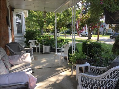 Love the covered front porch and gardens.