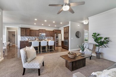 Living room featuring recessed lighting, ceiling fan, and light carpet
