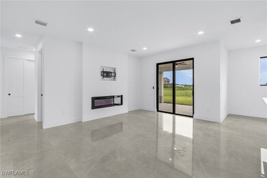 Unfurnished living room featuring light tile patte
