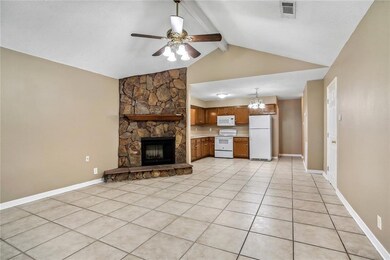 Den w/vaulted ceiling & stone FP