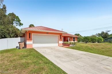 Single story home with concrete driveway, a metal roof, stucco siding, and an attached garage