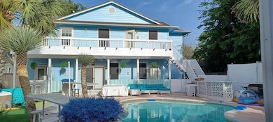 Rear view of house featuring an outdoor living sp