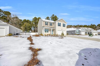 View of front of home featuring a garage and centr