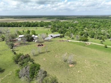 Aerial view of improvements, beautiful green trees