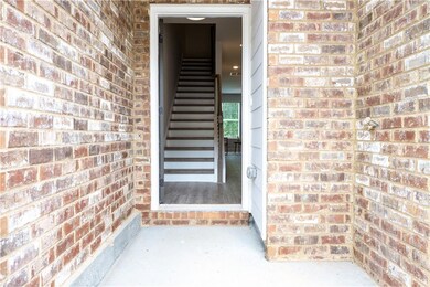 View of exterior entry featuring brick siding