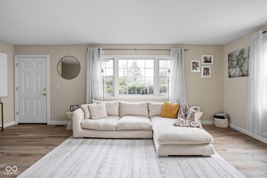 living room with baseboards and wood finished floors