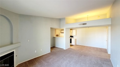 Unfurnished living room featuring carpet, baseboar