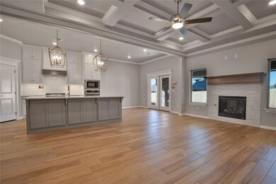 Kitchen featuring an island with sink, light hardw