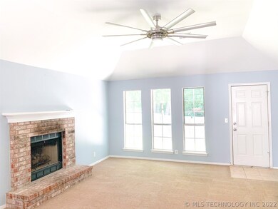 Living room with gas log fireplace and high coved