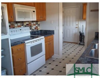 Kitchen. Smooth top range, microwave, and refriger