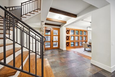ENTRY - Grand entryway with stone flooring, glass