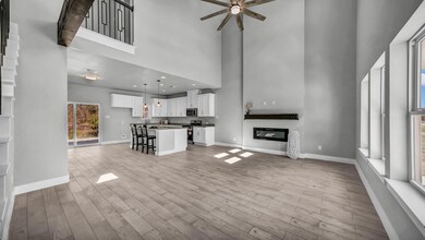 Unfurnished living room featuring baseboards, a hi