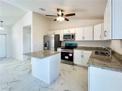 Kitchen with stainless steel appliances, vaulted c