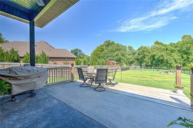 Homeowner added concrete patio and wood deck in backyard.