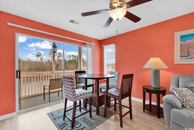 Dining room with visible vents, light wood-style flooring, baseboards, and a ceiling fan