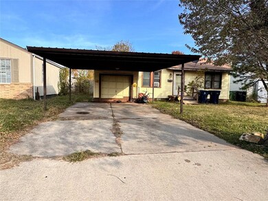 Ranch-style house with a front lawn and a carport