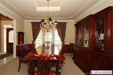 The formal dining room features a tray ceiling and