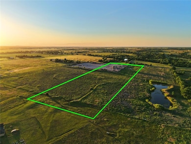 Aerial view at dusk of a view of countryside, property parcel outlined, and a water view