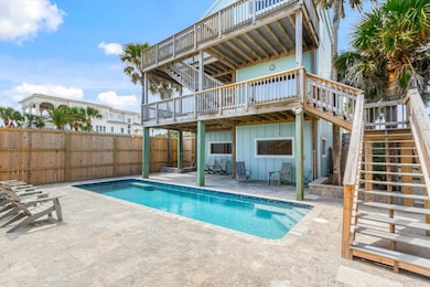 Rear view of property featuring stairway, board and batten siding, and a wooden deck