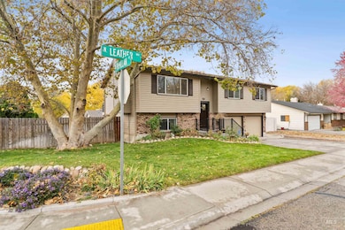 Split foyer home featuring brick siding, concrete driveway, and a garage