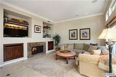 Cozy family room features crown molding, marble fi