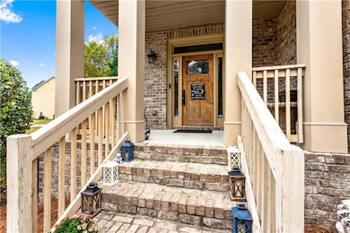 View of exterior entry with brick siding and cover