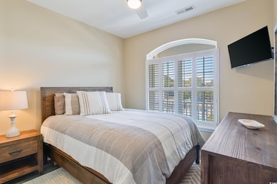 Bedroom with ceiling fan and multiple windows