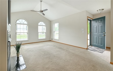 Sun drenched living room with plenty of windows and vaulted ceiling.
