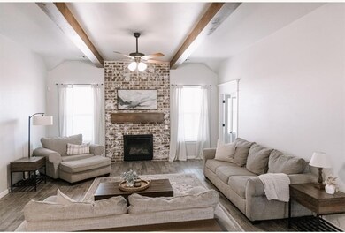 Living area with a fireplace, wood finished floors